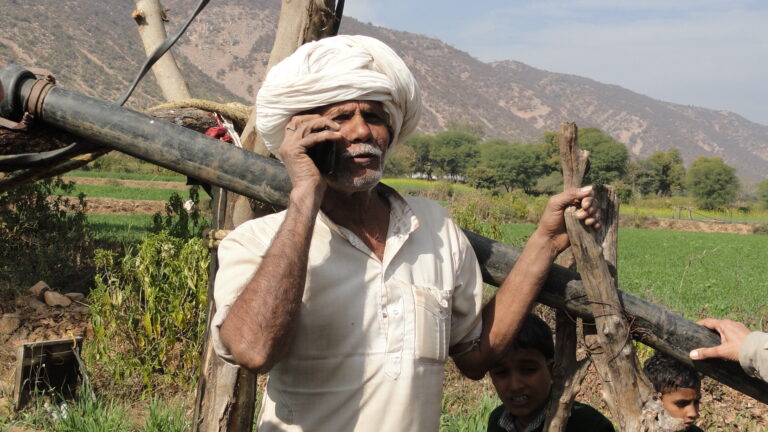 Photo 2 An elderly listening to the valuable information on his mobile phone