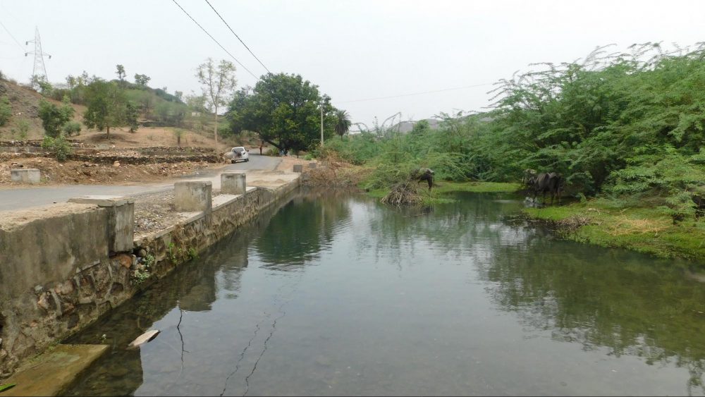 The polluted stream running through Kanpur village has been contaminated by a nearby tailings dam. Photo Credit: Dhaatri Resource Centre for Women and Children’s Rights.