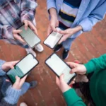 teens-in-circle-holding-smart-mobile-phones-and-writing-a-message